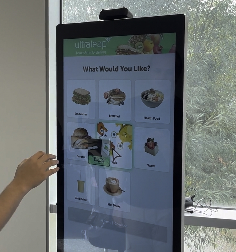 A kiosk with a quick service retail application being used. The user navigates through a series of food menus, selecting their order.